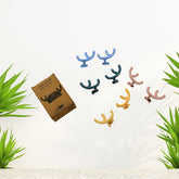 A pack of four white self-adhesive wall hooks, ready for easy installation.
