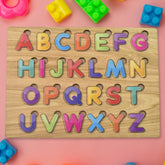 Wooden ABC Puzzle board with colourful letters and shapes for early learning.