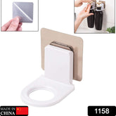 Multi-color adhesive bathroom hook mounted on a tiled wall, holding a bottle.