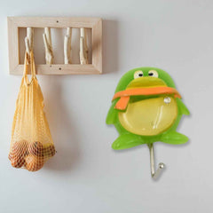 Cute green frog self-adhesive wall hook with strong backing, ready for installation.