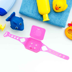 Overhead view of the Barbie-themed play set components arranged neatly, highlighting the toy phone, watch, and glasses.