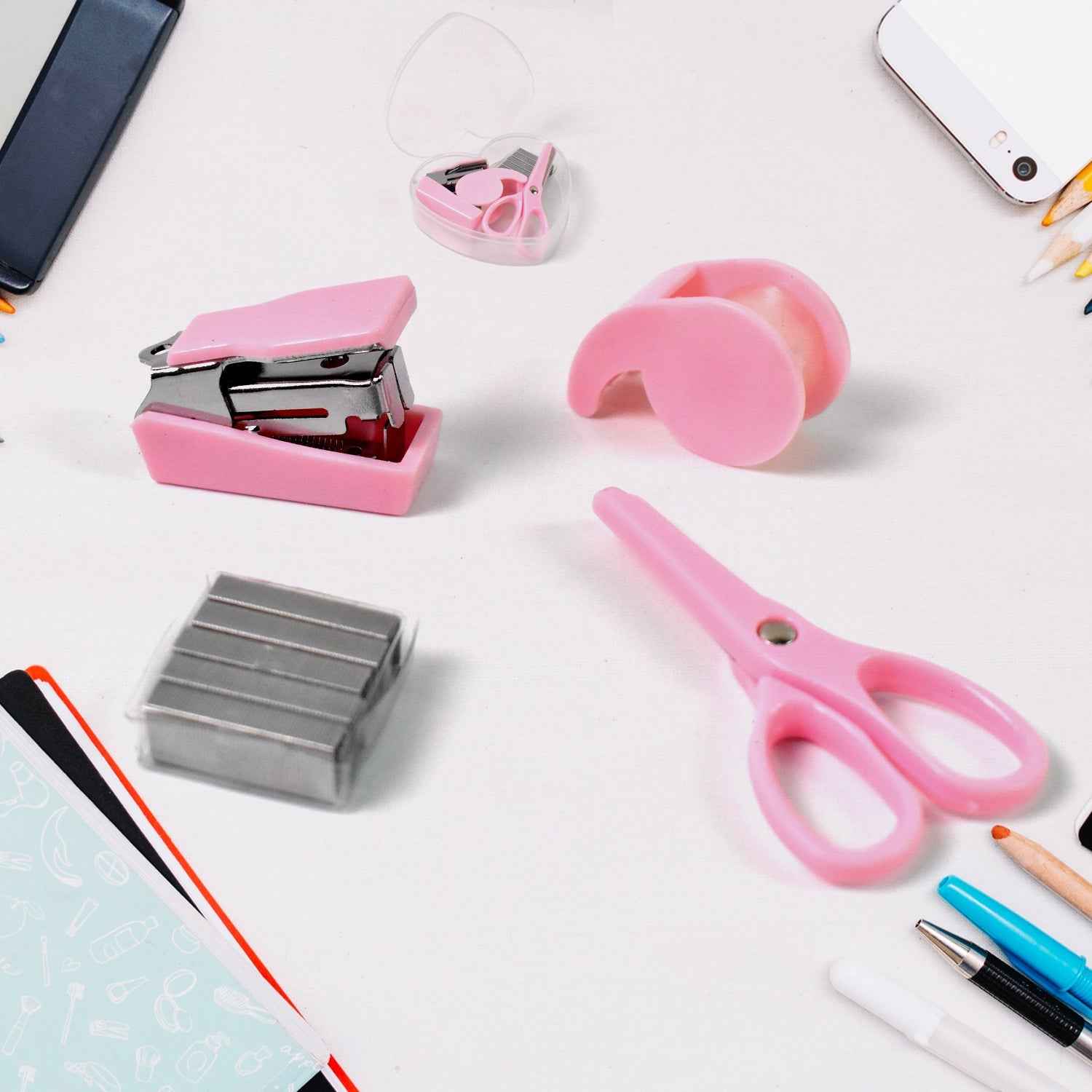 A clear plastic bottle containing a mini office stationery set, including a stapler, scissors, and tape dispenser.