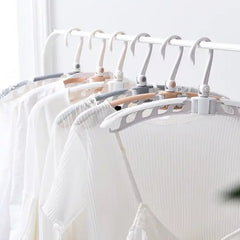 Adjustable arms of the folding clothes hanger demonstrated.
