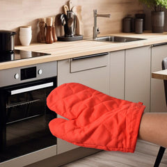 Person wearing a heat resistant oven mitt, safely handling a hot baking dish.