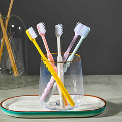 Soft plastic toothbrush set with vibrant colors and a portable round box, perfect for family oral hygiene.