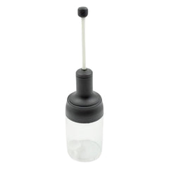 The sleek design of the Heat-Resistant Glass Seasoning Jar on a kitchen counter.