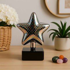 Star shaped 3D illusion LED night lamp showing multicolor light effect on a table
