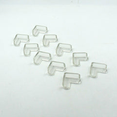 Multiple clear corner guards effectively applied to sharp furniture edges in a home.