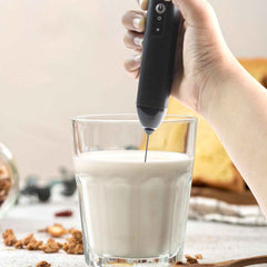 Closeup of stainless steel whisk on electric handheld milk frother