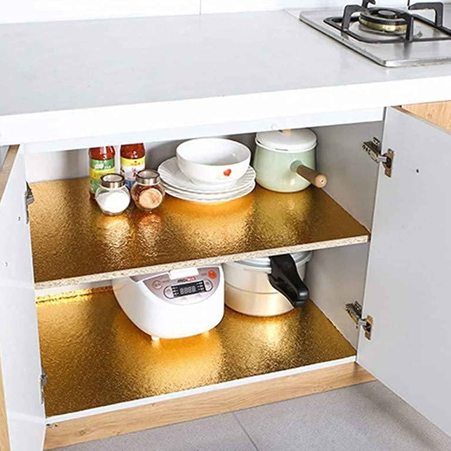 Golden oil-proof aluminum foil sticker installed on a kitchen wall.