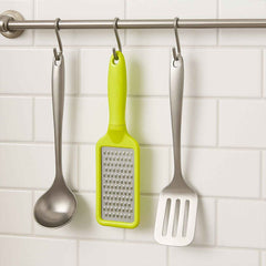 The ergonomic black plastic handle of the stainless steel grater, designed for a comfortable grip.