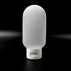 A single 60ml reusable plastic travel bottle in a vibrant mixed color, ready for toiletries.