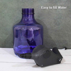 An electric garden sprayer gently misting a lush green plant for efficient and even watering.