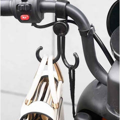 Multi-purpose stroller hook holding shopping bags and a purse on a pram.