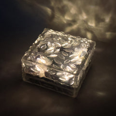 Close-up of a waterproof solar garden light, showcasing its frosted glass texture.