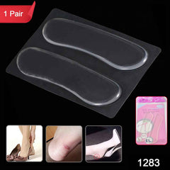 Hand holding a beige fabric heel cushion pad, showing the self-adhesive backing.
