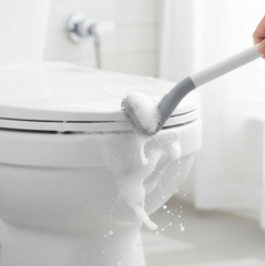 Wall-mounted holder securely storing the golf toilet brush, saving space.