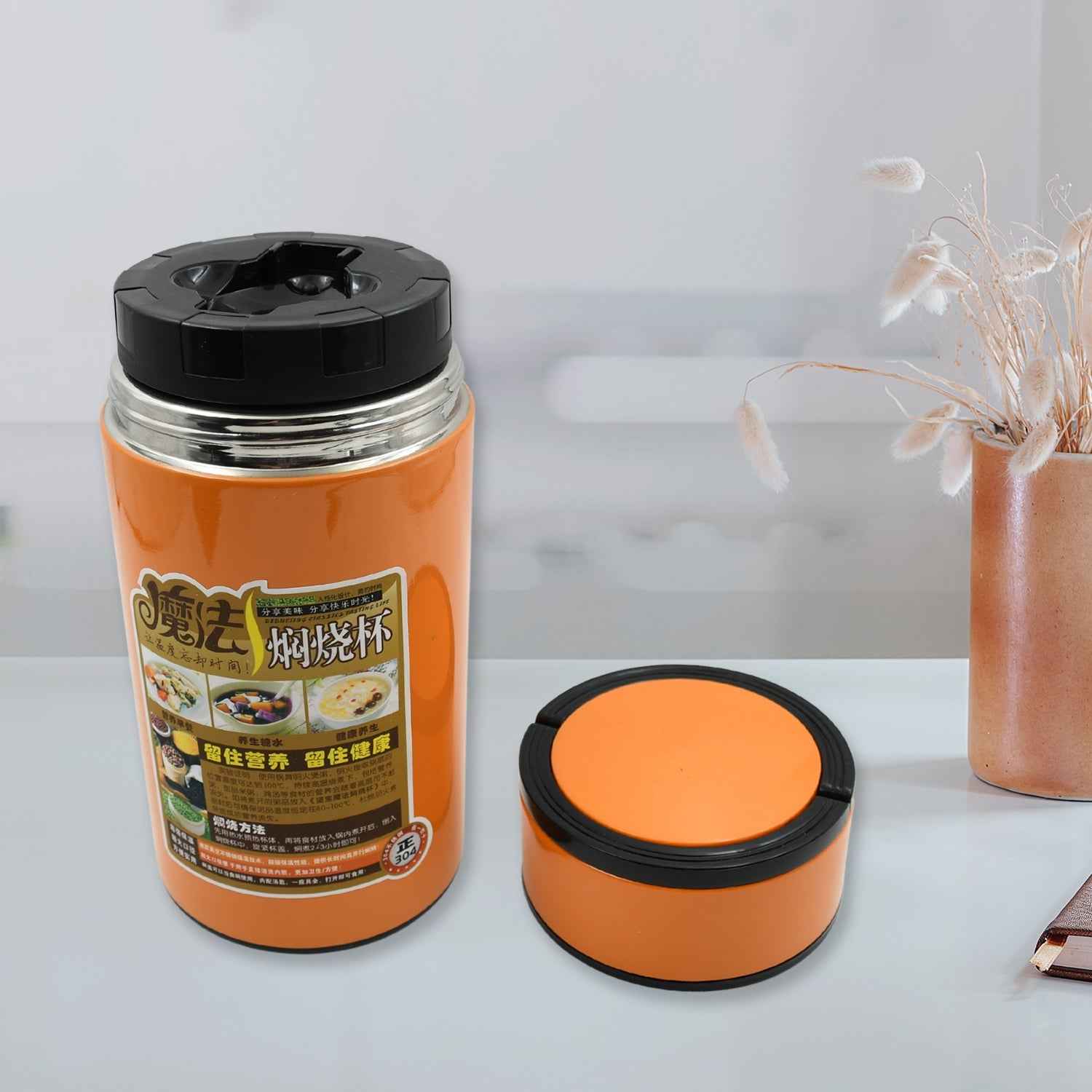 A sleek 1000ml Stainless Steel Water Bottle from VoltDesk with a foldable spoon and handle, shown against a clean background.