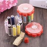 Compact sewing box open, revealing organized threads and sewing tools.