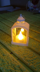 Arrangement of multiple flameless LED lanterns for a festive ambiance.