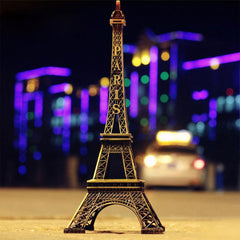 Antique finish Eiffel Tower statue on a white background.