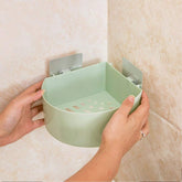 Self adhesive corner shelf installed in a modern bathroom.