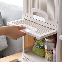 Close-up of ergonomic handles on the foldable storage cabinet's plastic drawers.