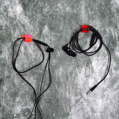 A set of multi-functional hand shape wall clips holding various items like cables and keys.