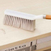 A durable household cleaning brush with a wooden handle, ideal for versatile dusting tasks.