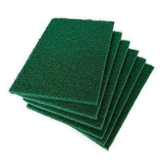 Green cleaning pads effortlessly removing grime from a kitchen tile surface.