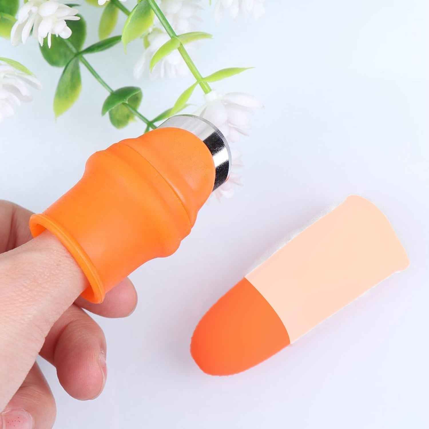 Close-up of the ergonomic vegetable thumb cutter on a hand.