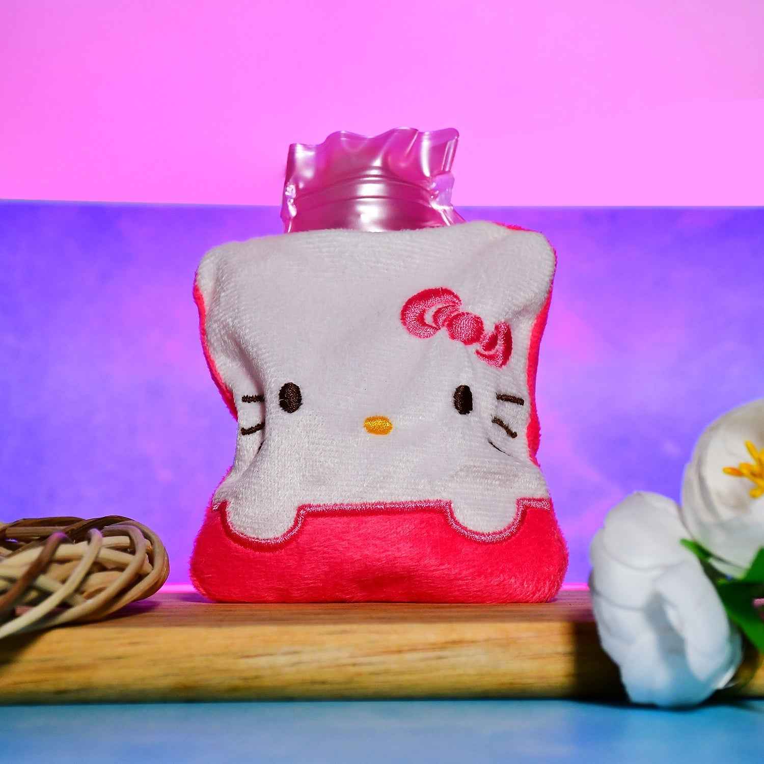 Pink hot water bag with a soft cover, ready for pain relief.