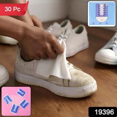 Person cleaning white sneaker with shoe cleaning wipe