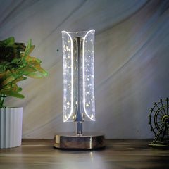 Crystal table lamp showcasing warm light and elegant golden base design