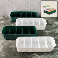 Four 5-compartment drawer organizers neatly stacked, storing socks and underwear.
