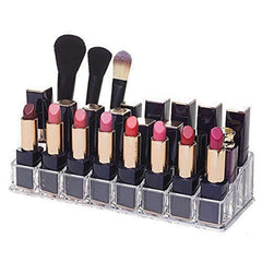 Clear acrylic lipstick holder with 24 sections, showcasing its organized cosmetic storage on a vanity.