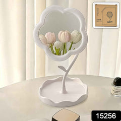 Side view of rotatable flower vanity mirror sitting on a tabletop