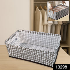 Stylish fabric storage bin placed on a wooden shelf, perfect for organizing clothes or linens.