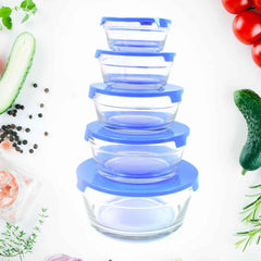 Close-up of a clear glass bowl with lid, holding a fresh fruit salad.