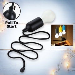 Black LED Pull Cord Light hanging, illuminated brightly to show its white light.
