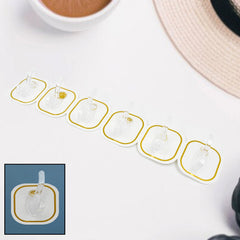 Set of six transparent adhesive hooks displayed neatly, ready for home organization.