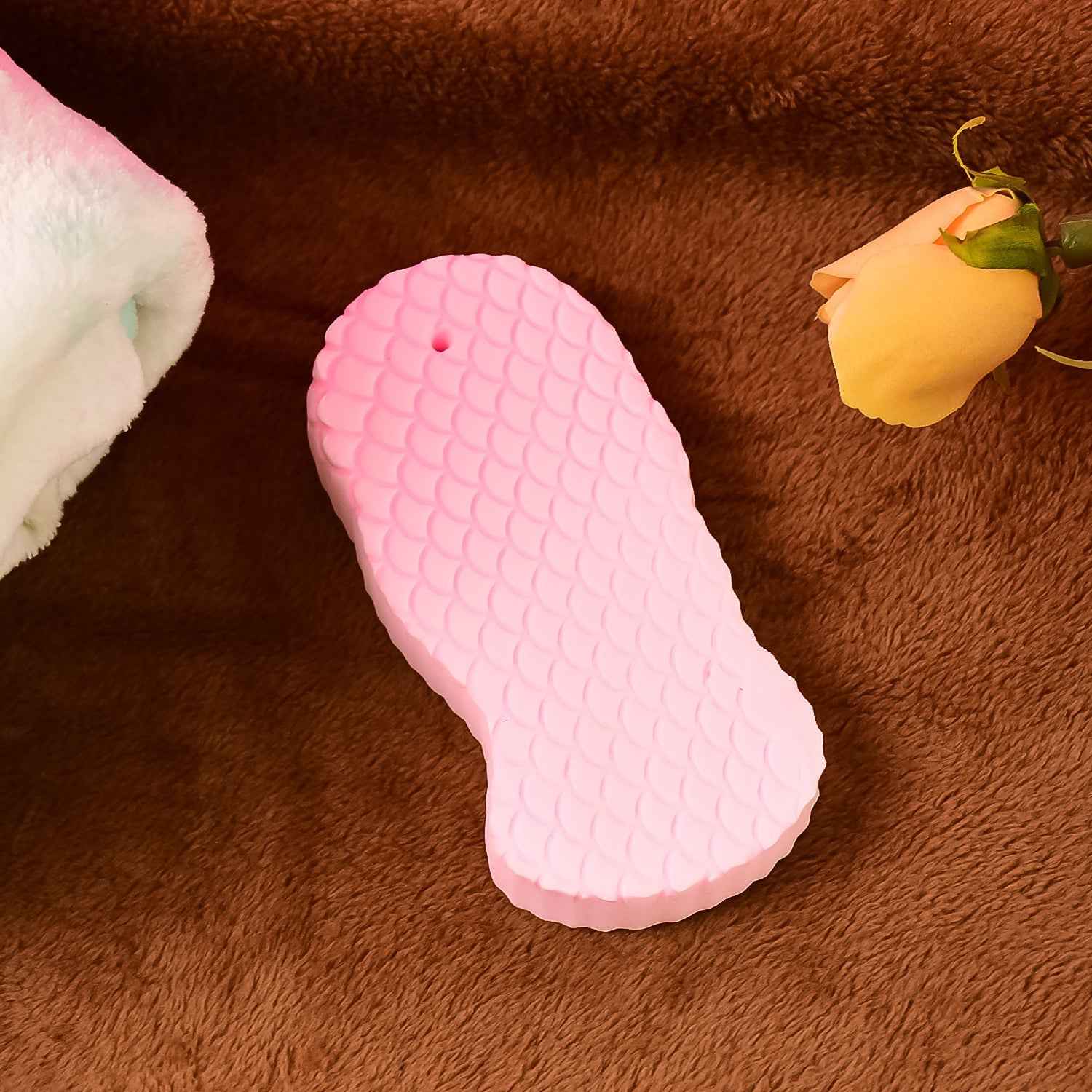 Ultra soft exfoliating sponge for gentle dead skin removal on face and body.