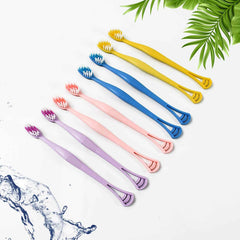 Close-up of the dual-action head of the toothbrush with soft bristles and integrated tongue scraper.