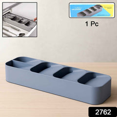 A plastic cutlery tray neatly filled with spoons, forks, and knives in a kitchen drawer.