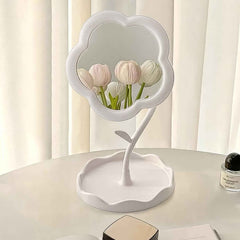 Flower-shaped makeup mirror providing clear reflection with integrated tray for essentials