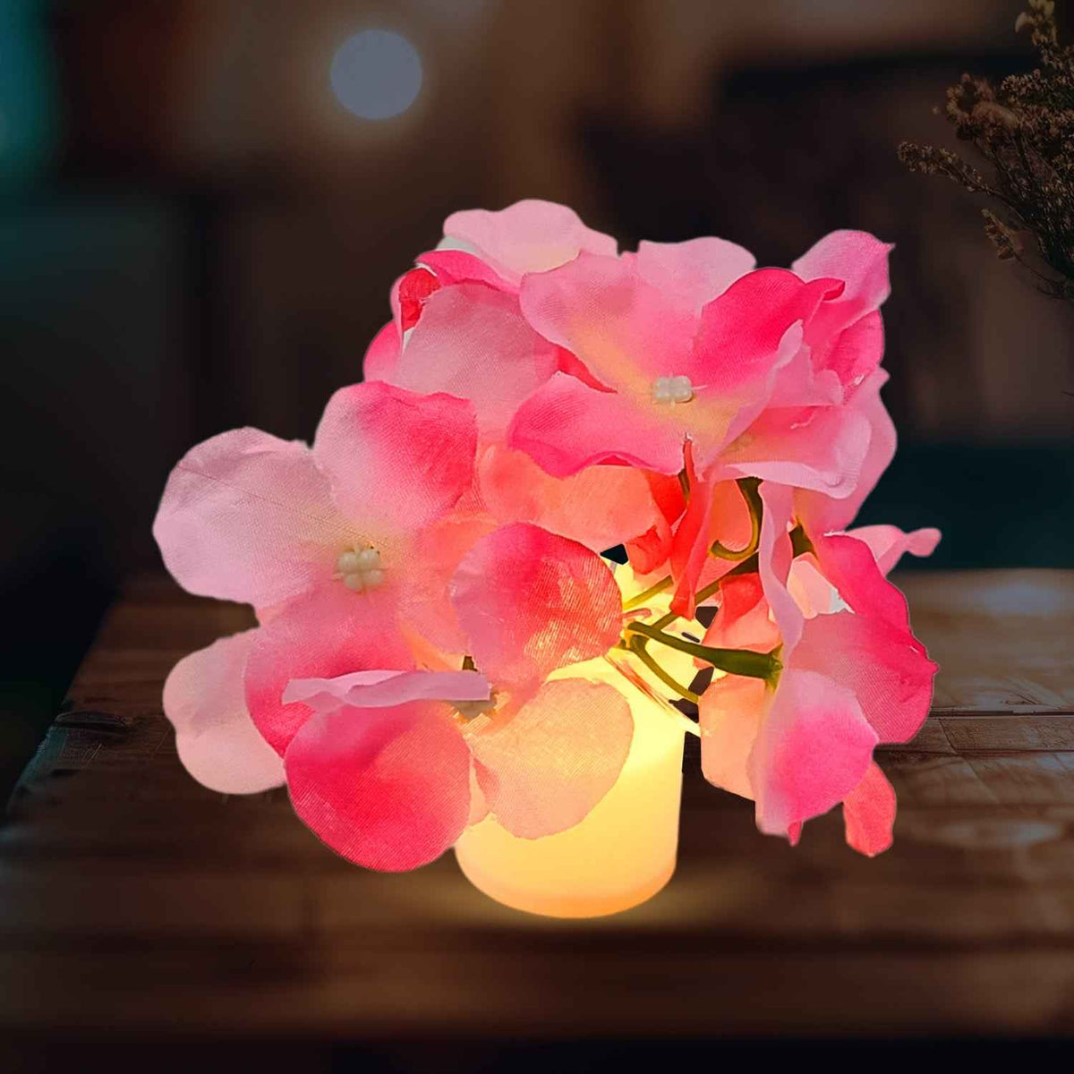 Elegant LED Mood Light with silk flowers in a glass vase, illuminating a modern living space.