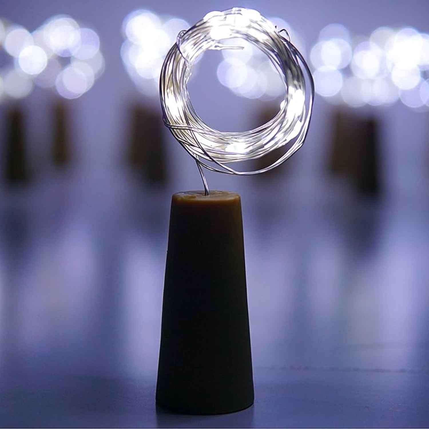 An illuminated wine bottle cork string light creating a warm ambiance on a wooden surface.