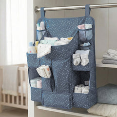 Close-up of storage pockets in baby care organizer for bottles and lotions