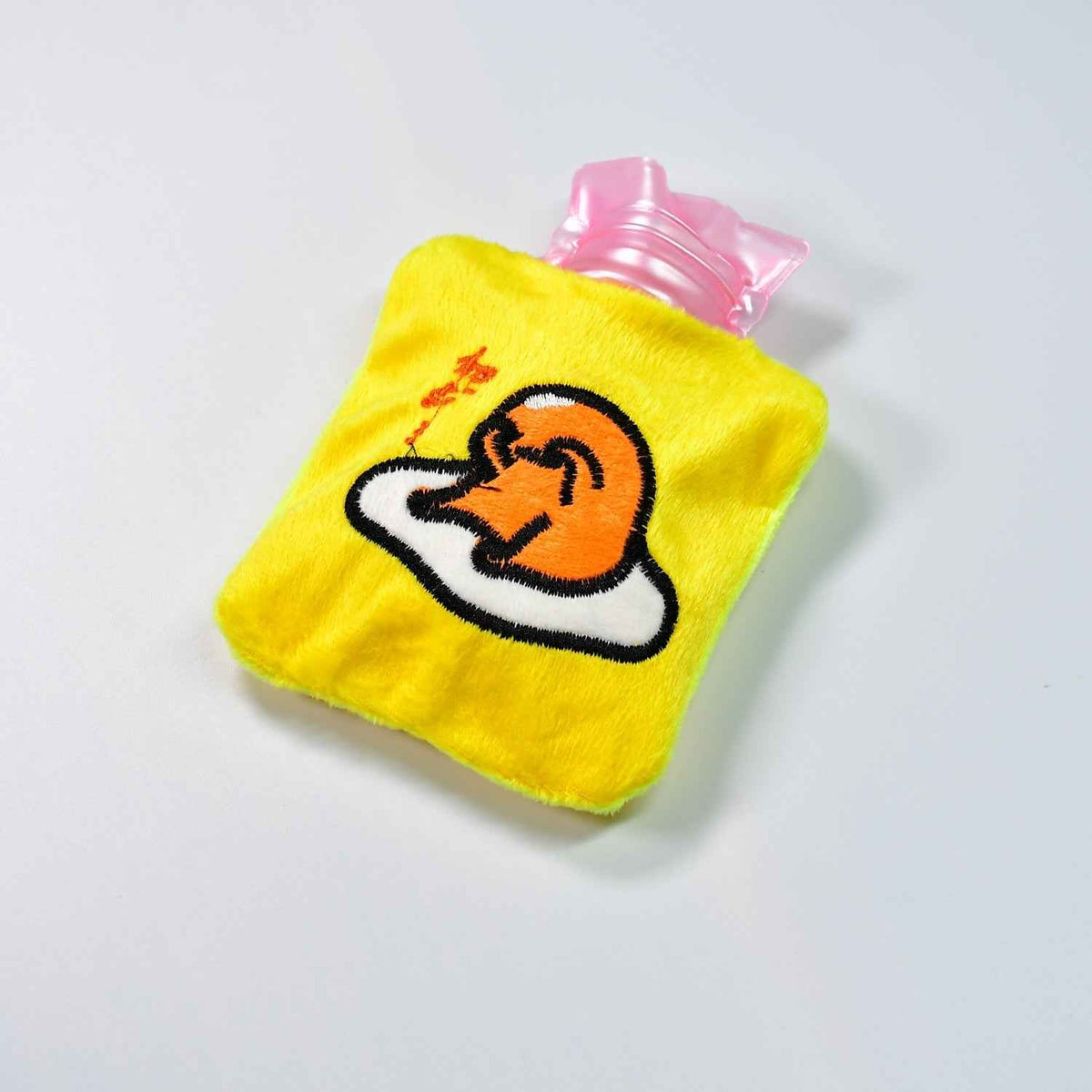 Bright yellow duck head hot water bag with a soft fabric cover for comfort.