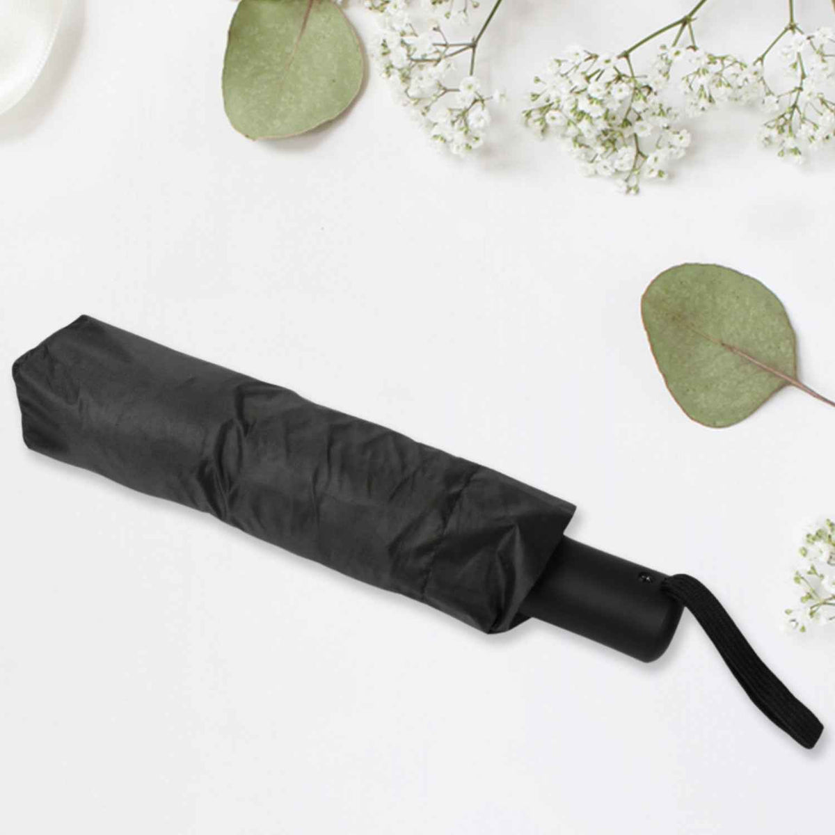 Compact umbrella easily sliding into a backpack pocket, highlighting its portability.